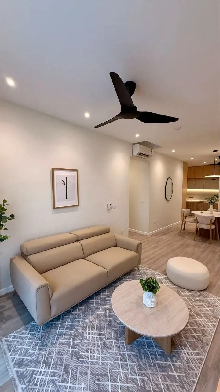 Finished condo living room with beige sofa, marble coffee table and backlit feature wall — view 2