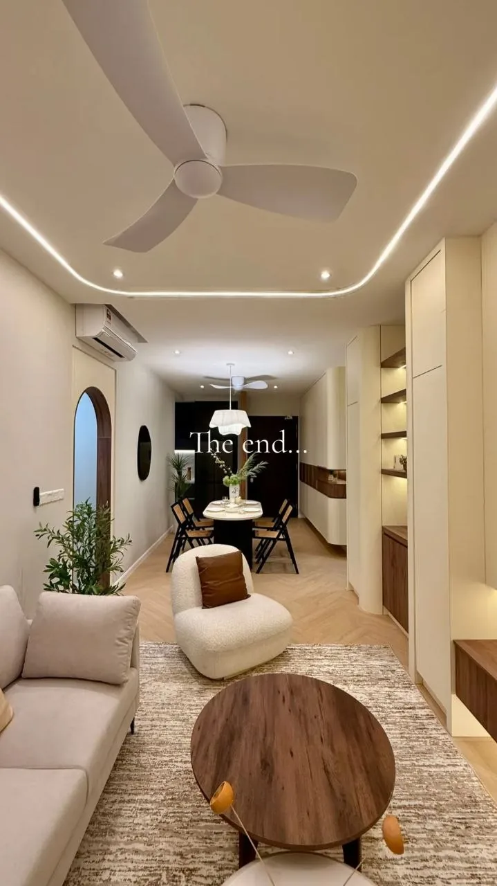 Finished condo living room with beige sofa, marble coffee table and backlit feature wall — view 8