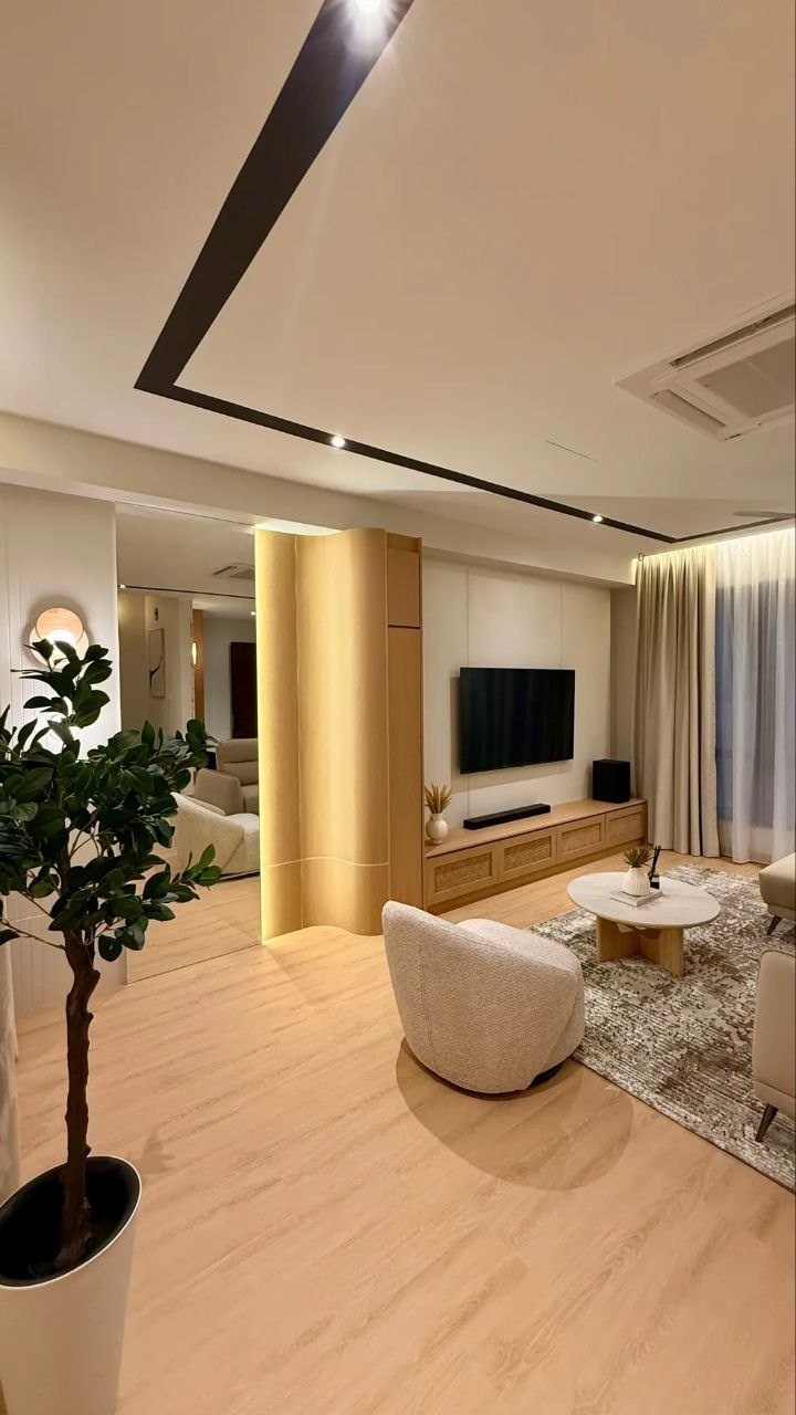 Landed home living area with warm wood TV console, sofa and ceiling fan — view 3